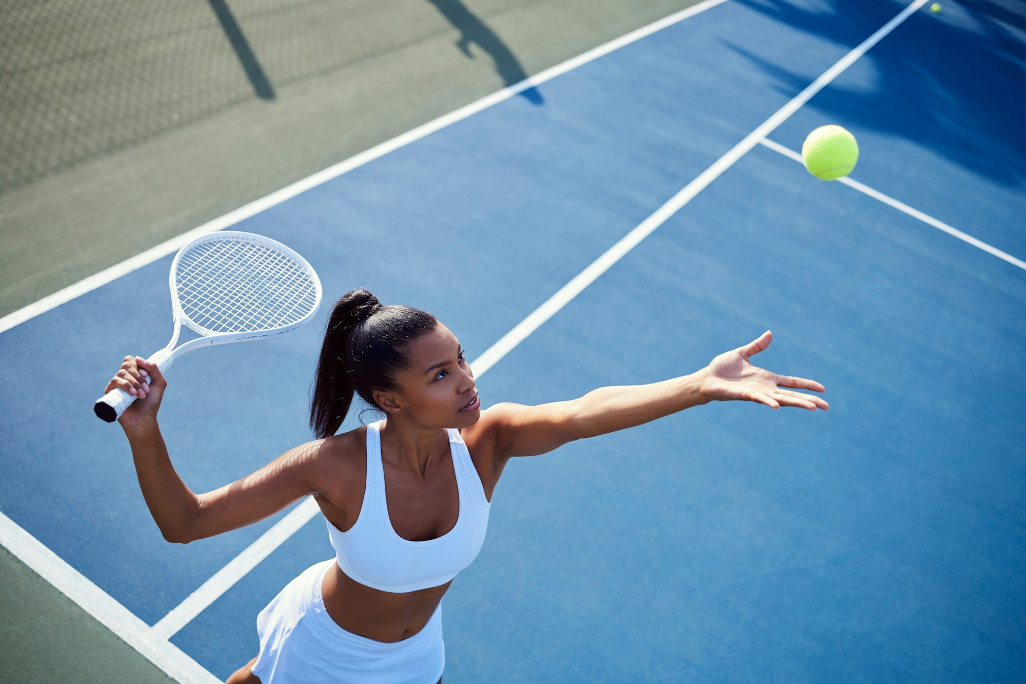 Keep moving forward. Shot of an attractive young woman playing tennis outside.