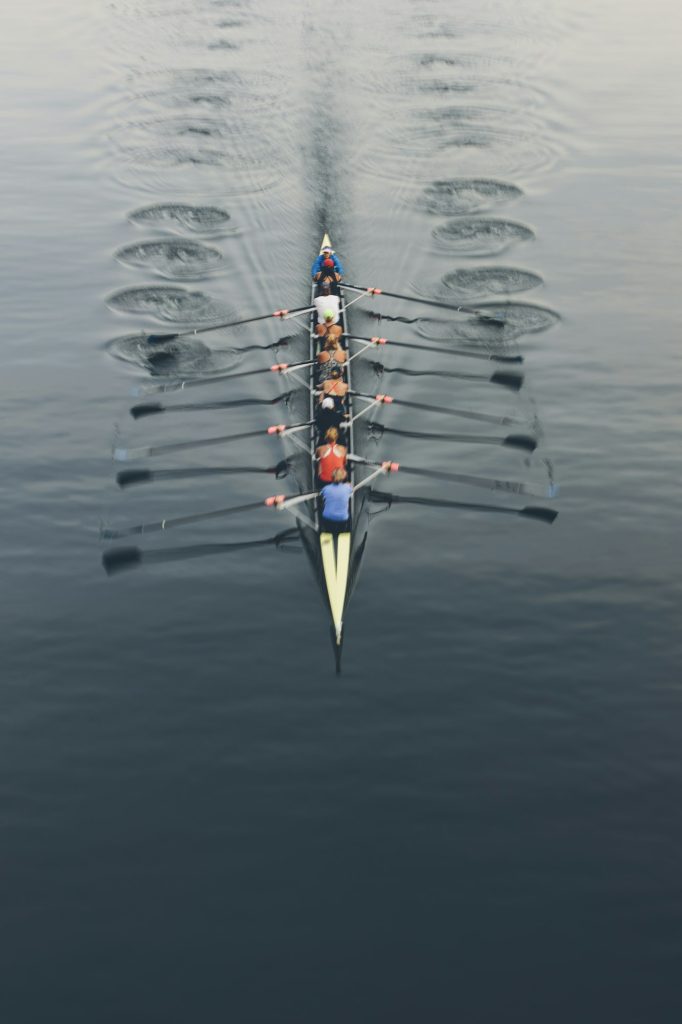 Overhead view of a crew in an eights boat rowing on a lake